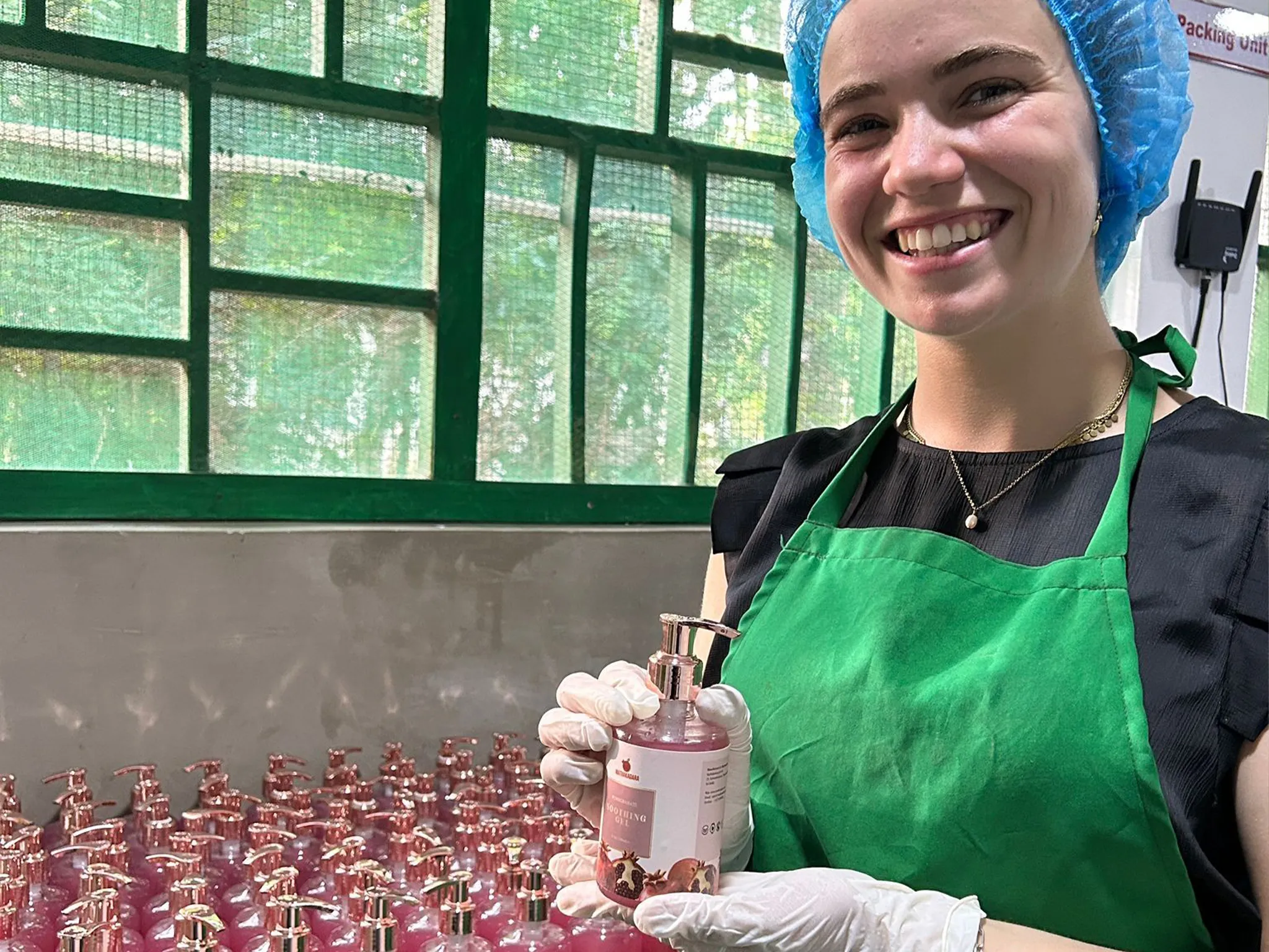 Foreign intern showcasing organic wellness product at Mathakadara facility